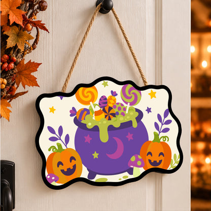 Pancarte Chaudron de Sucettes Étoilées peinte et accrochée à une porte d'entrée décorée pour Halloween — Maison Artsen