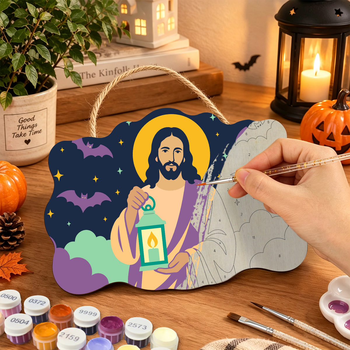 Pancarte Christ à la Lanterne en cours de peinture, pinceau à la main — Maison Artsen