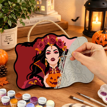 Pancarte Vampire aux Roses Rouges en cours de peinture, pinceau à la main — Maison Artsen
