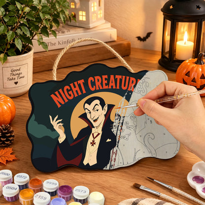 Pancarte Vampire et Chat Noir en cours de peinture, pinceau à la main — Maison Artsen